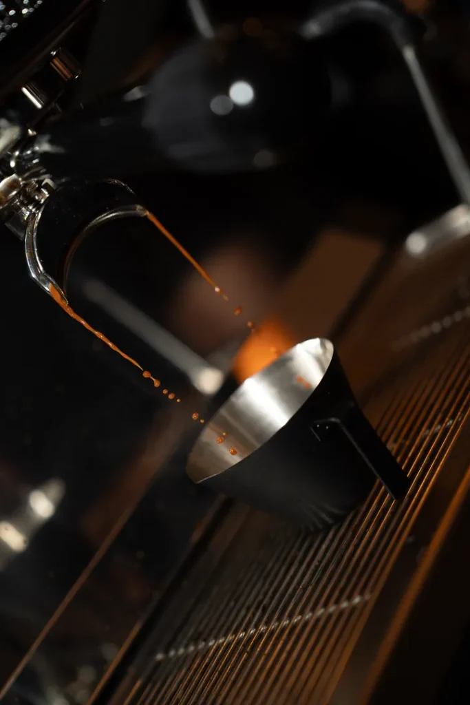 Fresh espresso pouring into metal cups at Sowa.