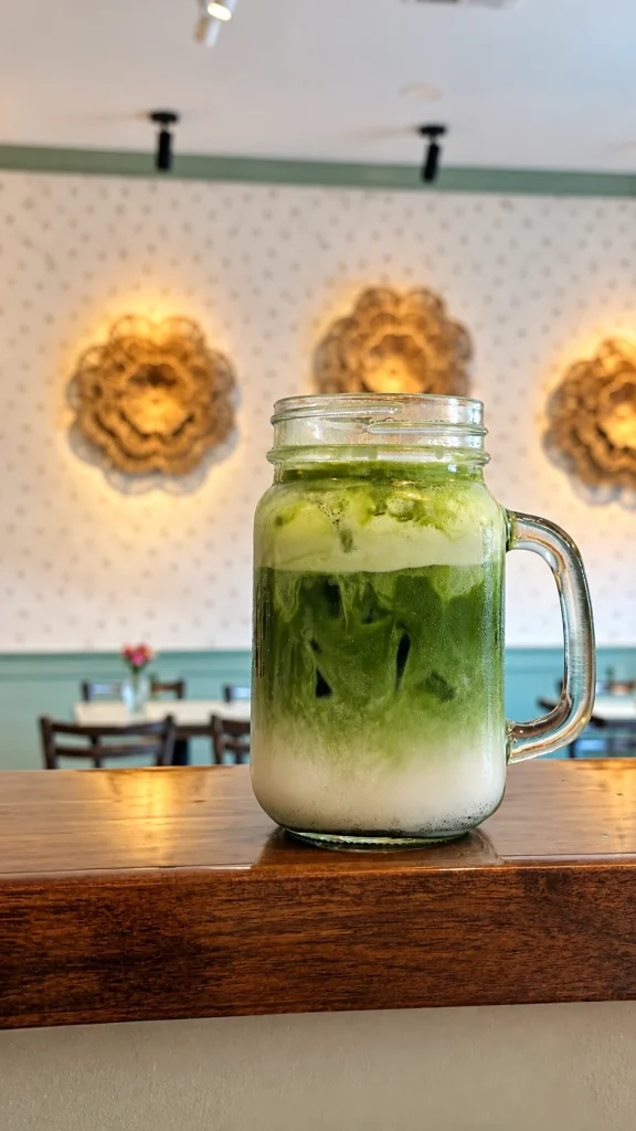Iced matcha drink in a glass jar on the Sowa counter.