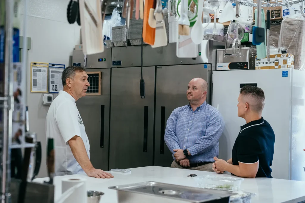 People talking in the Sowa restaurant kitchen.